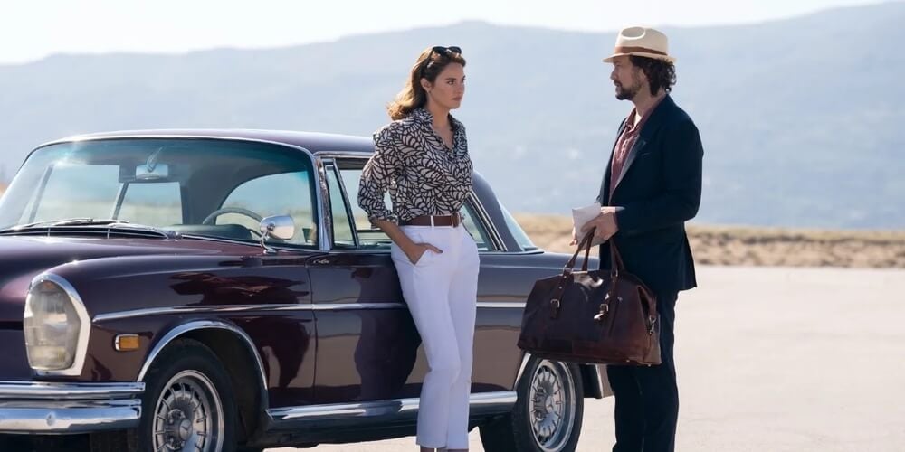 Shailene Woodley leans against a car as Joseph Gordon-Levitt approaches with a bag in 